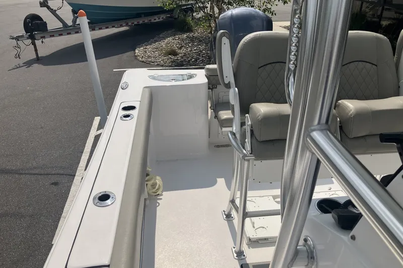 Slide: The Image of 2023 Sportsman Open 232 Center Console boat interior with seating and rod holders. - 14