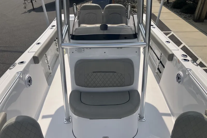 Slide: The Image of 2023 Sportsman Open 232 Center Console boat interior with seating and console view. - 12