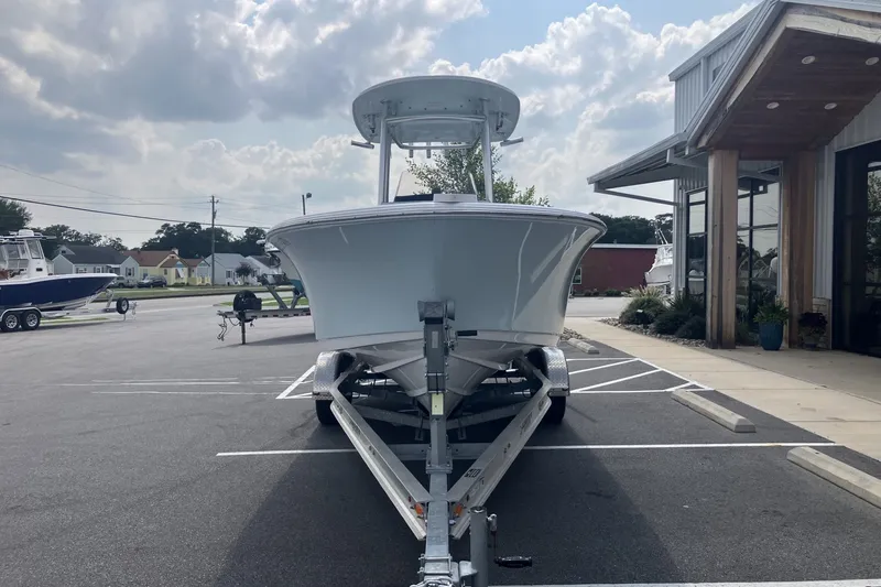 Slide: The Image of 2023 Sportsman Open 232 Center Console boat on trailer in parking lot. - 3