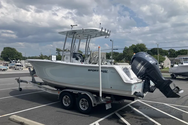 Slide: The Image of 2023 Sportsman Open 232 Center Console boat on trailer in parking lot. - 2