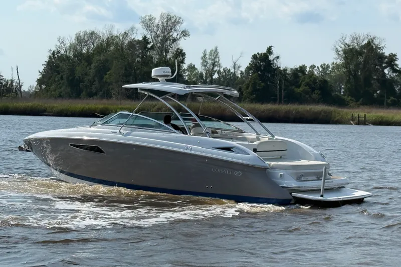 Slide: The Image of 2018 Cobalt R35 boat cruising on a river with lush greenery in the background. - 32