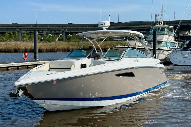 Slide: The Image of 2018 Cobalt R35 boat docked on a sunny day, featuring sleek design and modern amenities. - 5