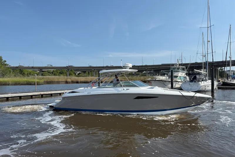 Slide: The Image of 2018 Cobalt R35 boat docked in a marina under a clear blue sky. - 4