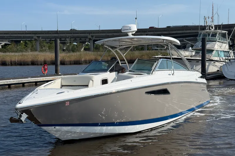 Slide: The Image of 2018 Cobalt R35 boat docked on a sunny day with bridge in background. - 1