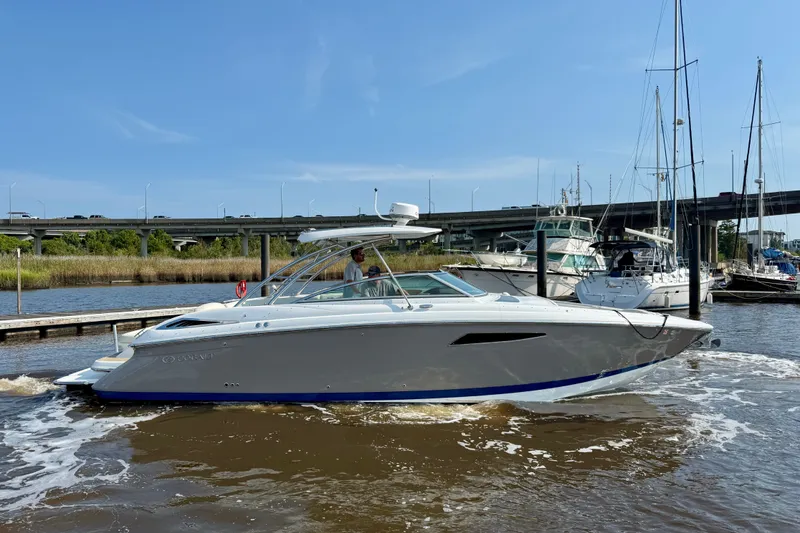 Slide: The Image of 2018 Cobalt R35 boat cruising in a marina under a clear blue sky. - 3