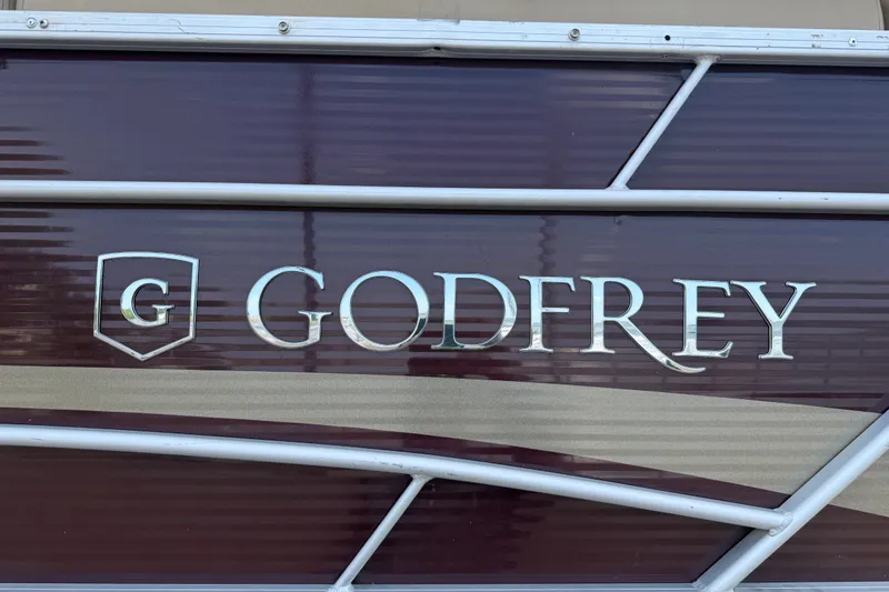Slide: The Image of 2021 Godfrey Sweetwater 2286 FS boat logo on maroon background. - 24