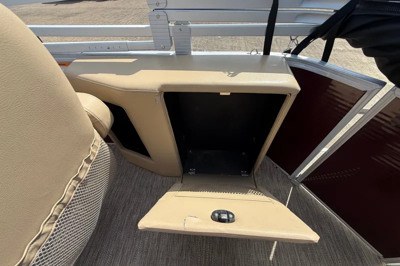 Slide: The Image of Open storage compartment on 2021 Godfrey Sweetwater 2286 FS boat, featuring beige interior. - 44