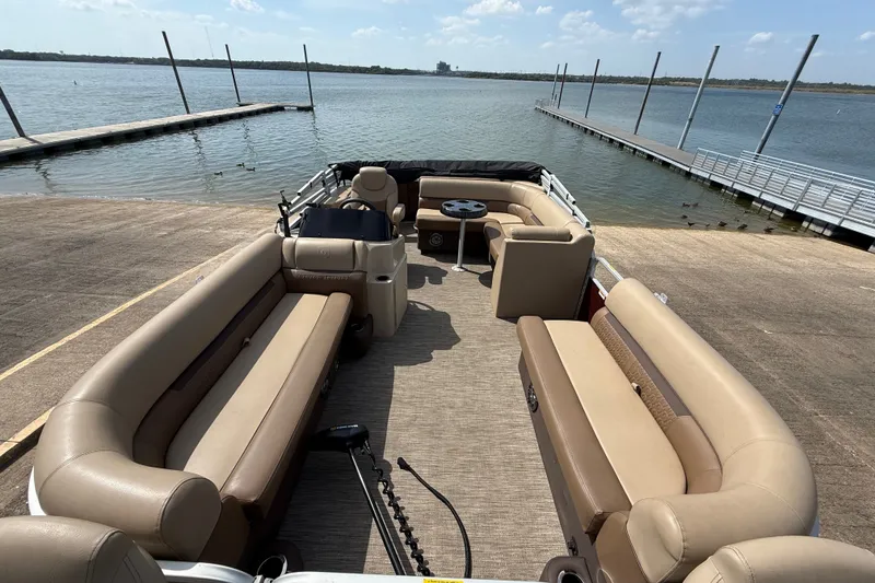 Slide: The Image of 2021 Godfrey Sweetwater 2286 FS pontoon boat docked by a serene lake. - 32