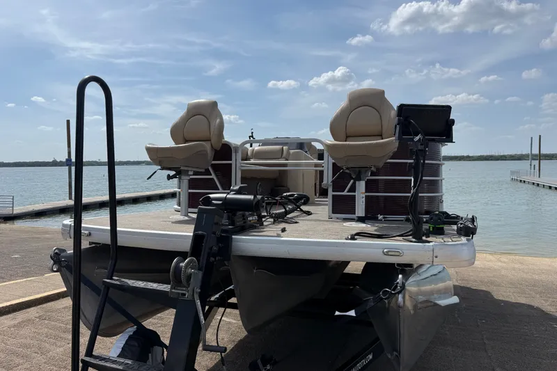 Slide: The Image of 2021 Godfrey Sweetwater 2286 FS pontoon boat docked by a serene lake. - 12
