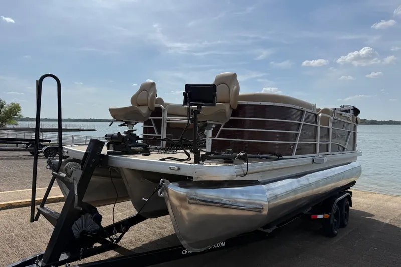Slide: The Image of 2021 Godfrey Sweetwater 2286 FS pontoon boat on trailer by a lake. - 18