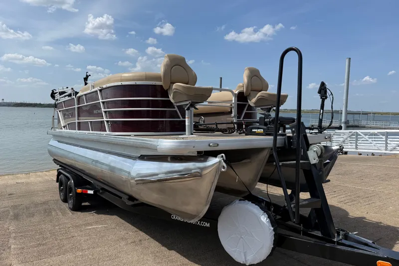 Slide: The Image of 2021 Godfrey Sweetwater 2286 FS pontoon boat on trailer by the water. - 4