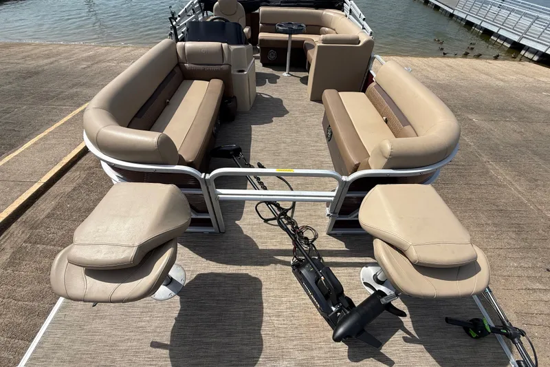 Slide: The Image of 2021 Godfrey Sweetwater 2286 FS pontoon boat with beige seating, docked by the water. - 29