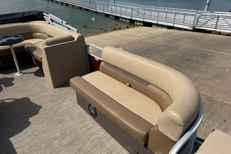 Slide: The Image of 2021 Godfrey Sweetwater 2286 FS pontoon boat with beige seating near a dock. - 33