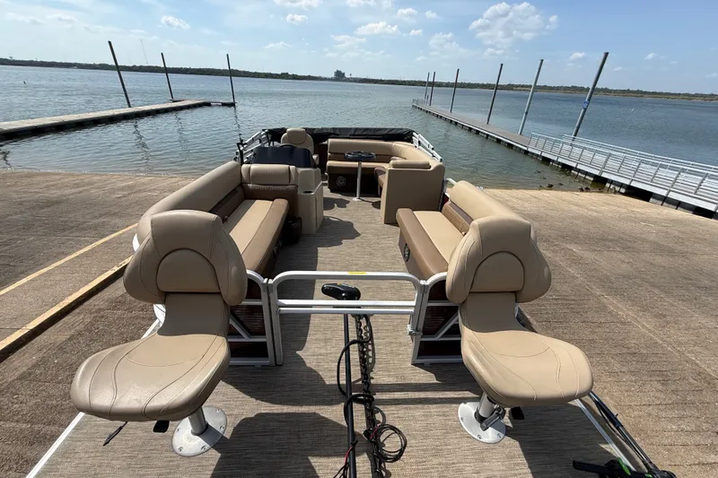 Slide: The Image of 2021 Godfrey Sweetwater 2286 FS pontoon boat docked by a serene lake. - 28