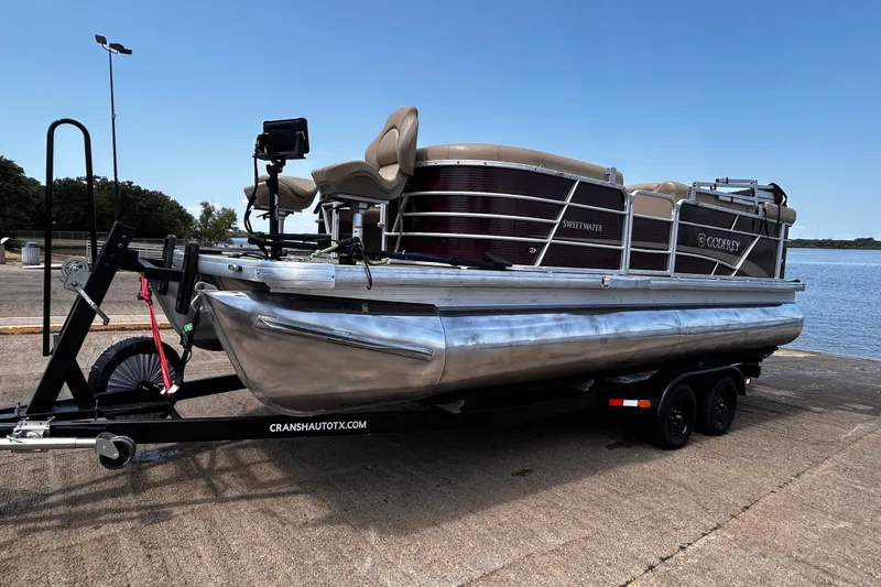Slide: The Image of 2021 Godfrey Sweetwater 2286 FS pontoon boat on trailer by the water. - 70