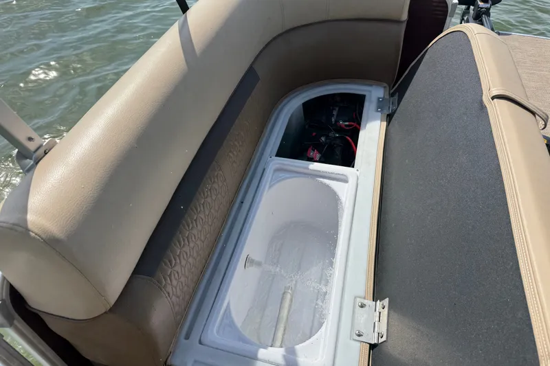 Slide: The Image of 2021 Godfrey Sweetwater 2286 FS boat seat storage compartment with open lid, revealing interior. - 54