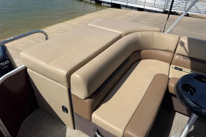 Slide: The Image of 2021 Godfrey Sweetwater 2286 FS boat interior with beige seating and cup holders. - 51