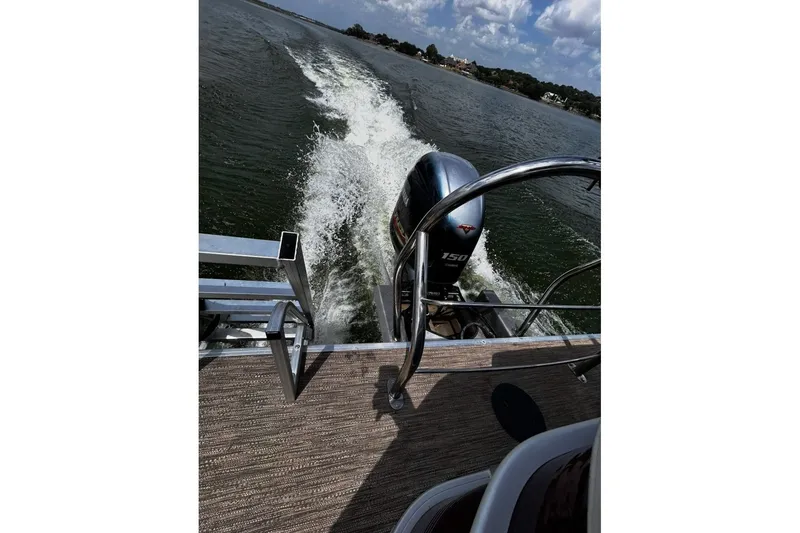 Slide: The Image of 2021 Godfrey Sweetwater 2286 FS boat cruising on a lake with visible wake. - 65