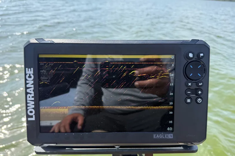 Slide: The Image of Lowrance fish finder on Godfrey Sweetwater 2286 FS, 2021 model, displaying sonar data on water. - 59