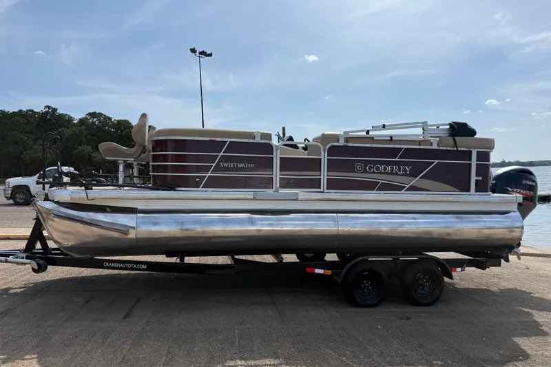 Slide: The Image of 2021 Godfrey Sweetwater 2286 FS pontoon boat on trailer by the water. - 5