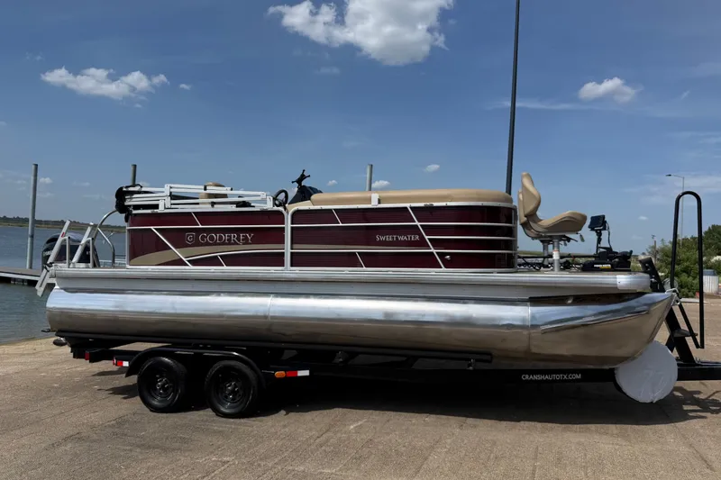 Slide: The Image of 2021 Godfrey Sweetwater 2286 FS pontoon boat on trailer by the lake. - 13