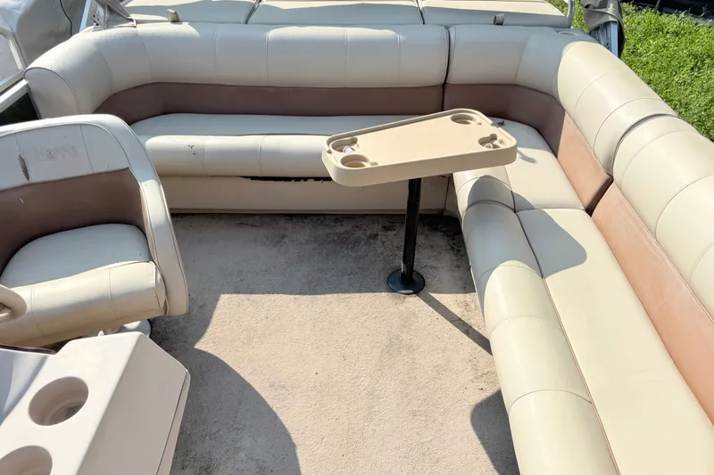 Slide: The Image of Interior of a 1998 Harris FloteBote 220 Classic pontoon boat with beige seating and table. - 8