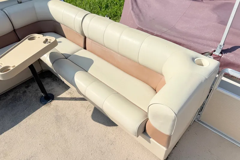 Slide: The Image of 1998 Harris FloteBote 220 Classic boat seating with beige and tan upholstery, featuring a cupholder table. - 7