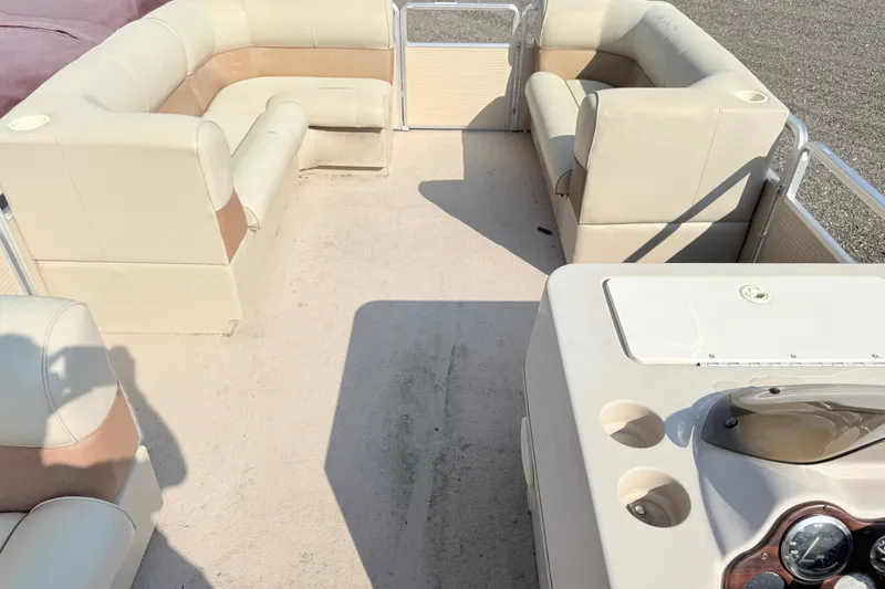 Slide: The Image of 1998 Harris FloteBote 220 Classic pontoon boat interior with beige seating and helm. - 12