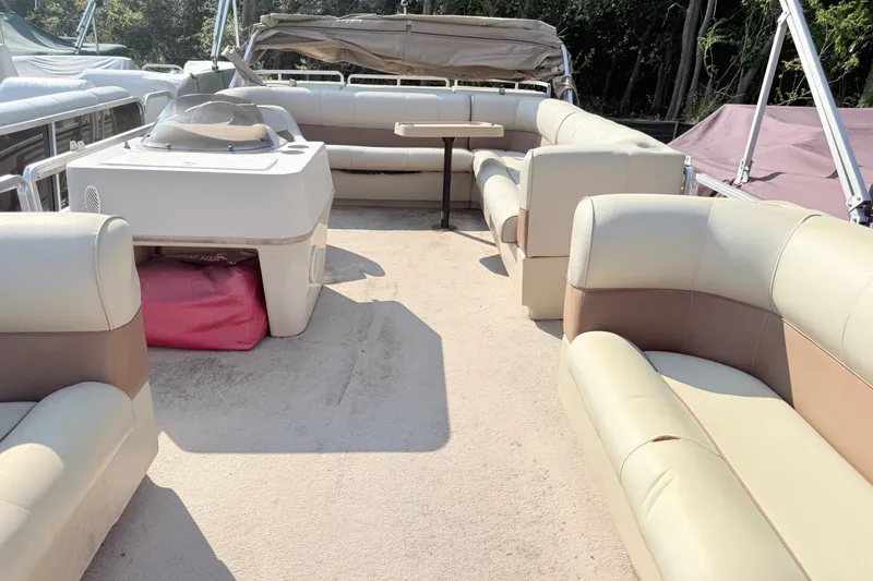 Slide: The Image of 1998 Harris FloteBote 220 Classic pontoon boat interior with beige seating and table. - 5