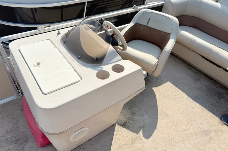 Slide: The Image of 1998 Harris FloteBote 220 Classic boat interior with steering console and seating. - 6