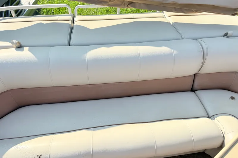 Slide: The Image of 1998 Harris FloteBote 220 Classic boat seating with beige upholstery in sunlight. - 11