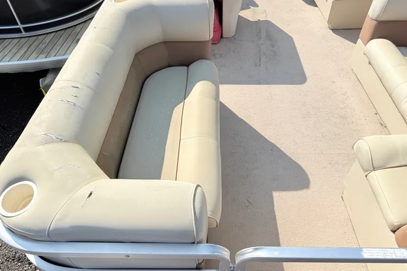 Slide: The Image of 1998 Harris FloteBote 220 Classic pontoon boat interior with beige seating and cup holders. - 4