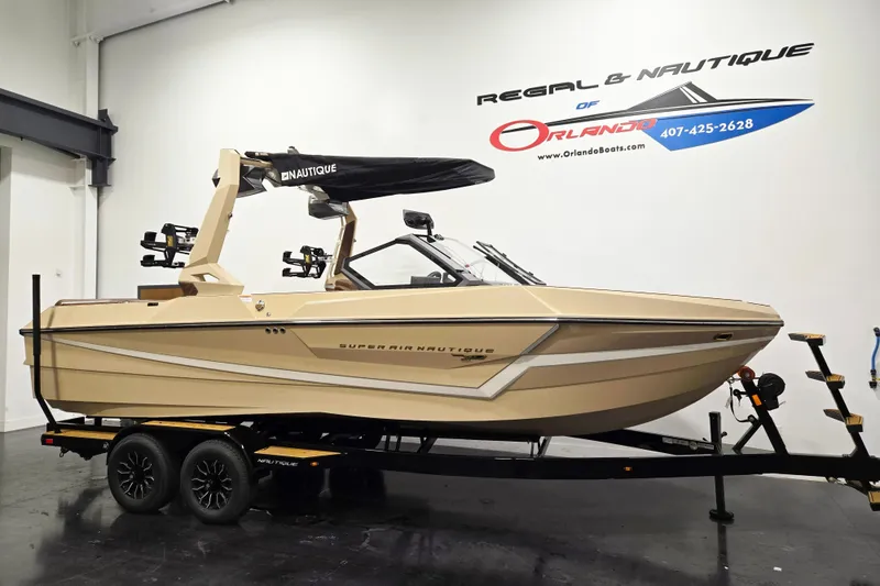 The Image of The image shows a 2027 Super Air Nautique S23 boat in a showroom. - 1