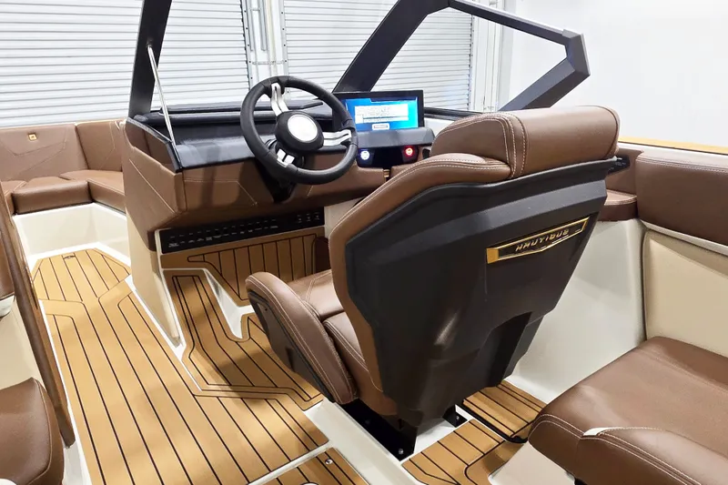 Slide: The Image of Interior of a modern boat with brown leather seats and a digital dashboard. - 9