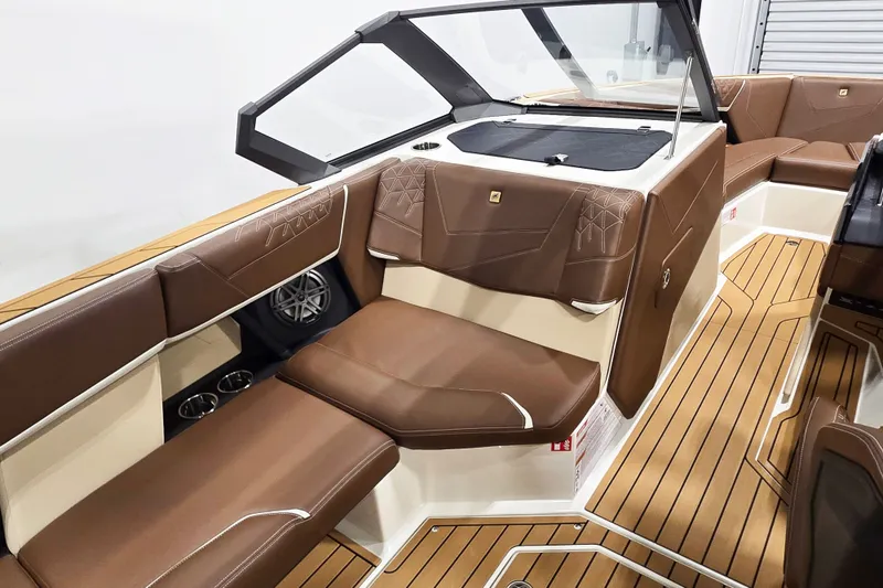 Slide: The Image of The image shows the interior of a 2027 Nautique Super Air Nautique S23 with brown leather seating. - 8