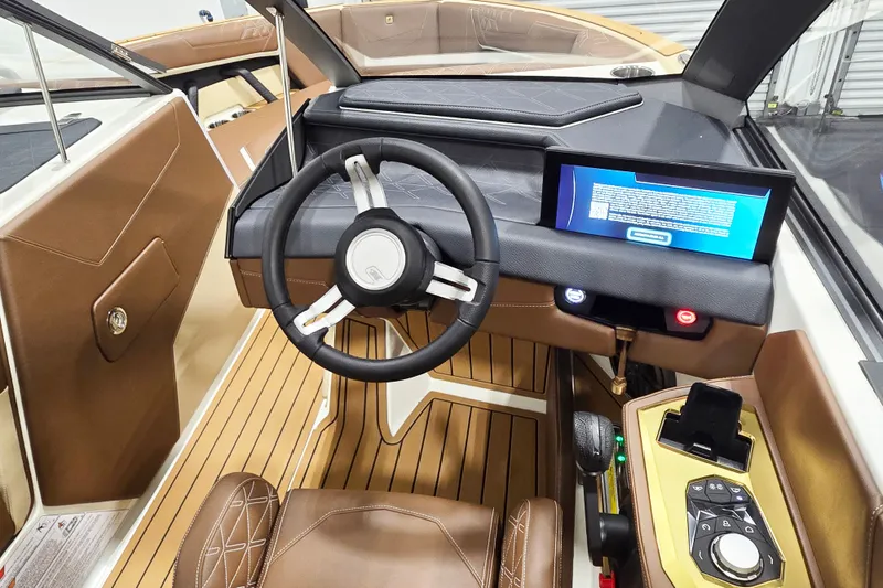 Slide: The Image of The cockpit of the 2027 Nautique Super Air Nautique S23 features a modern steering wheel and digital display. - 10