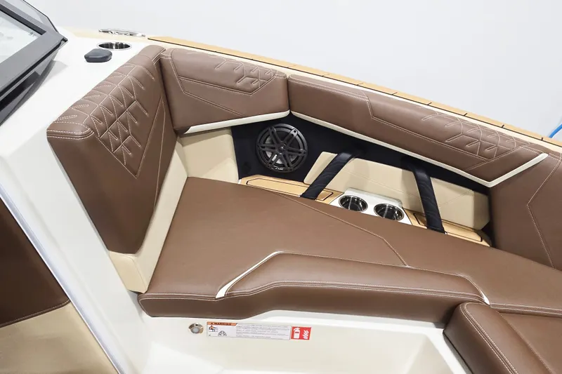 Slide: The Image of The interior view shows brown upholstered seats with sleek stitching and speakers in the bow area. - 7