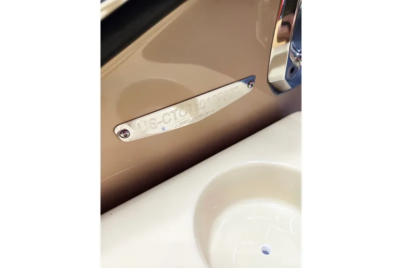 Slide: The Image of Close-up of a boat detail with a metal plaque and a cup holder. - 13