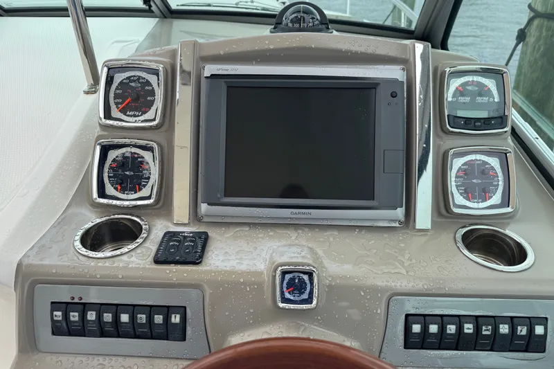 Slide: The Image of Dashboard of a 2013 Chaparral 330 Signature boat with gauges and Garmin display. - 9