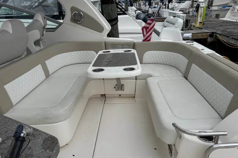 Slide: The Image of 2013 Chaparral 330 Signature boat interior with cushioned seating and table. - 5