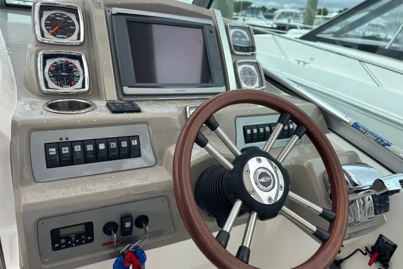 Slide: The Image of Cockpit of 2013 Chaparral 330 Signature boat with steering wheel and control panel. - 8
