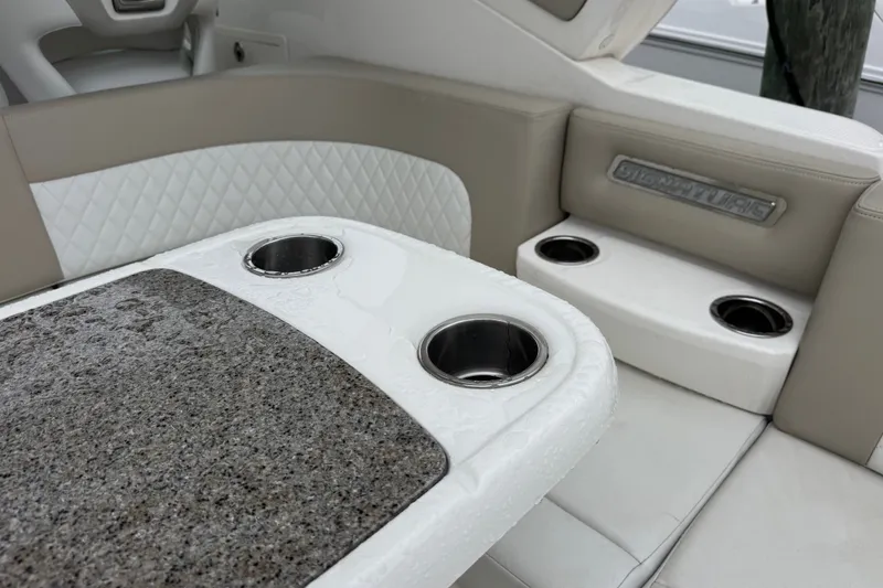 Slide: The Image of Interior of 2013 Chaparral 330 Signature boat with cup holders and cushioned seating. - 6