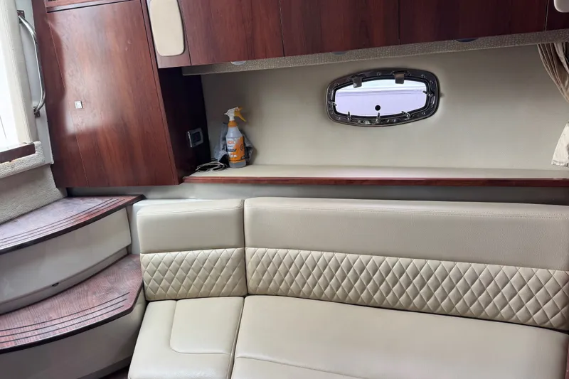 Slide: The Image of Interior of 2013 Chaparral 330 Signature yacht with leather seating and wooden cabinetry. - 16