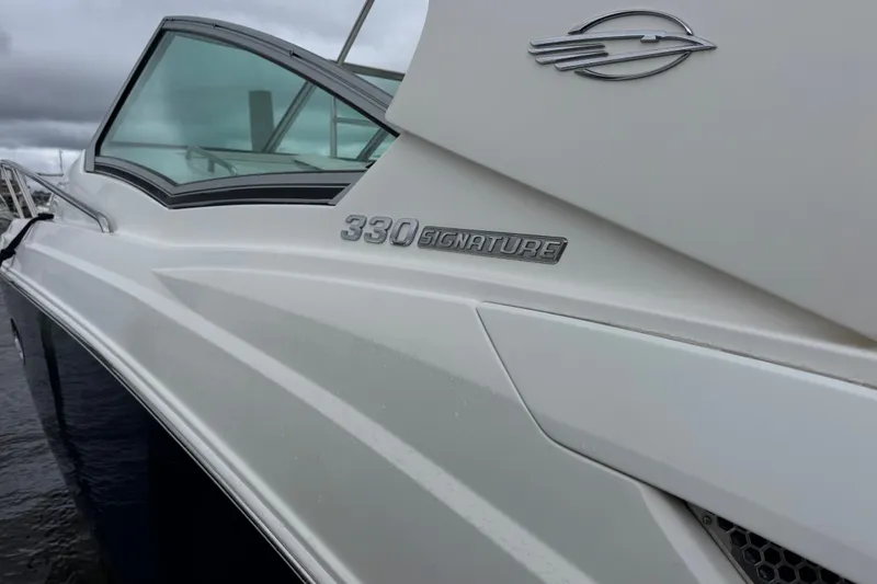 Slide: The Image of Chaparral 330 Signature 2013 boat, sleek white exterior with logo and model name visible. - 3