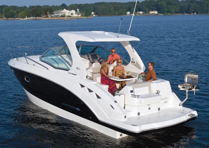 Slide: The Image of Manufacturer Provided Image: 2013 Chaparral 330 Signature boat with people enjoying a meal on the water. - 21
