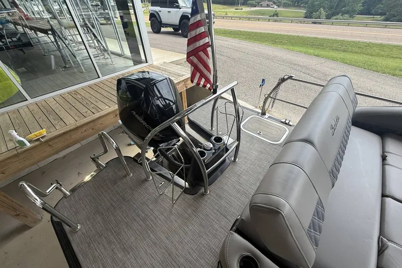 Slide: The Image of 2021 Barletta L25U pontoon boat with outboard motor and American flag. - 13