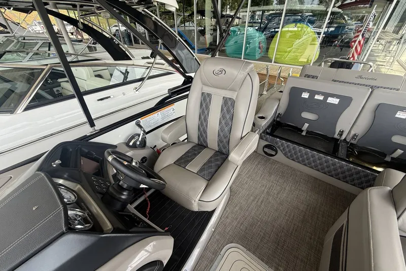Slide: The Image of Interior of a 2021 Barletta L25U boat featuring luxurious seating and modern controls. - 10