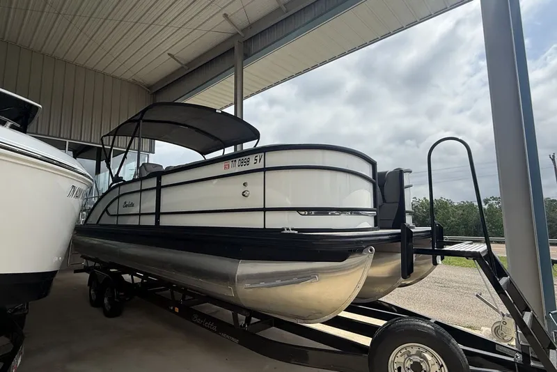 Slide: The Image of 2021 Barletta L25U pontoon boat on trailer under shelter. - 3