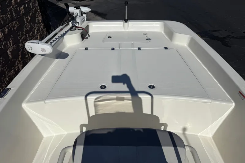 Slide: The Image of 2023 Mako Pro Skiff 17 CC boat deck with trolling motor and seating area. - 11