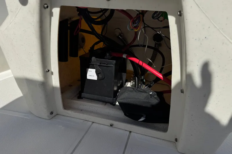 Slide: The Image of 2023 Mako Pro Skiff 17 CC battery compartment with wiring and components. - 27